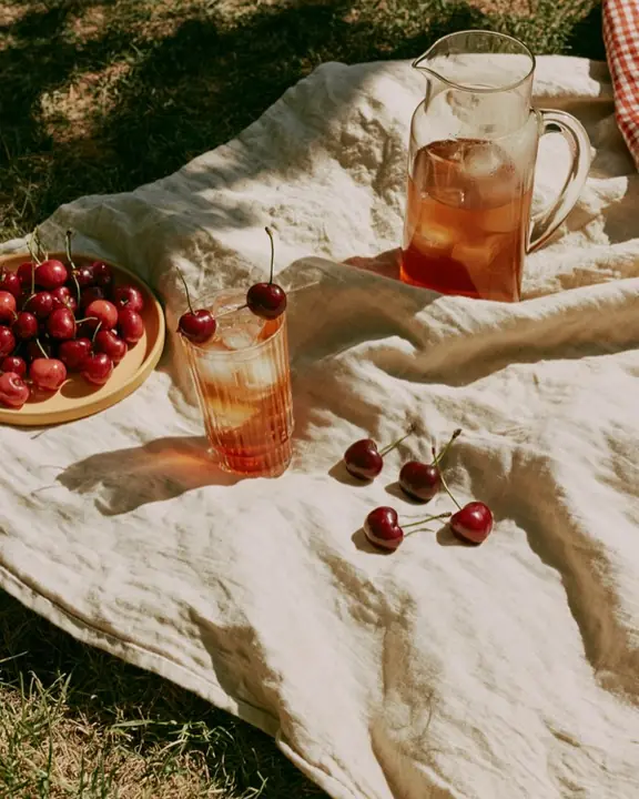 Editorial shot of a picnic blanket laid out on grass